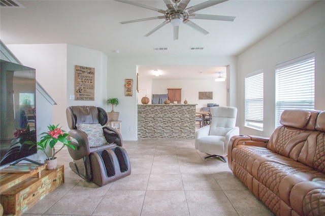 living room with ceiling fan and light tile patterned floors