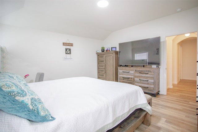 bedroom featuring light wood-type flooring and lofted ceiling