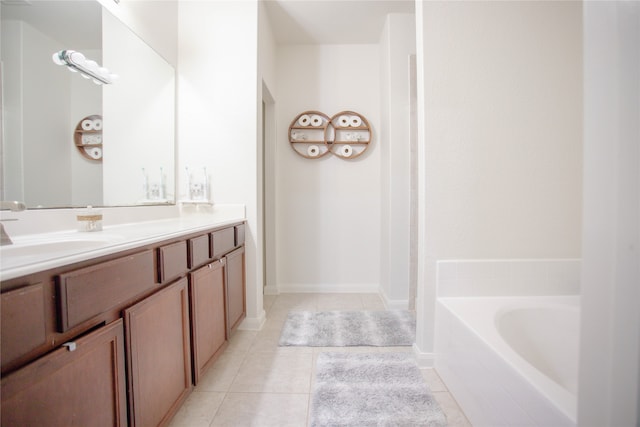 bathroom featuring vanity, tile patterned flooring, and a bath