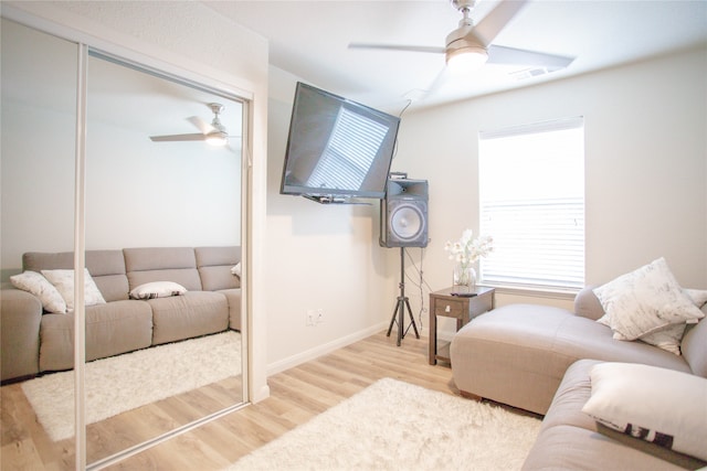 living room featuring ceiling fan and hardwood / wood-style flooring