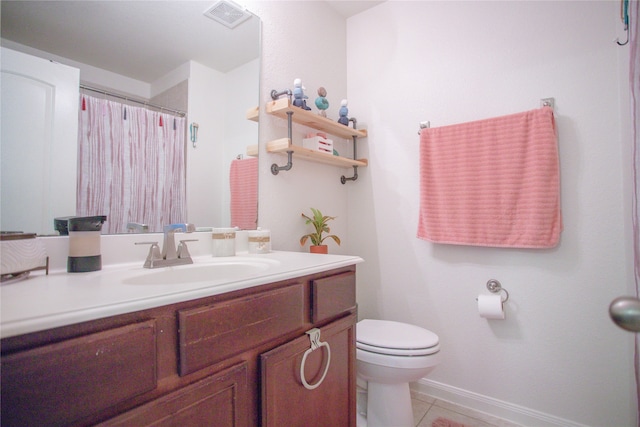 bathroom with vanity, toilet, and tile patterned floors