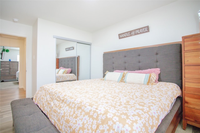 bedroom with a closet and light wood-type flooring