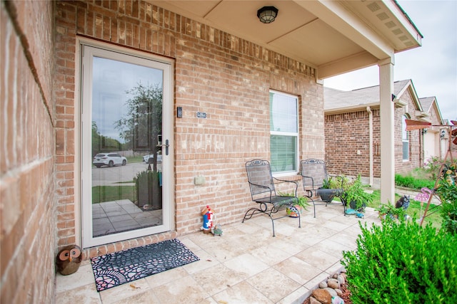 entrance to property with a patio