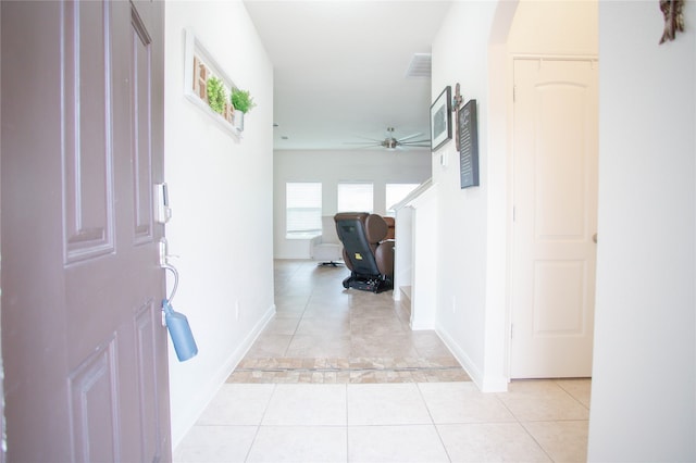 corridor featuring light tile patterned floors