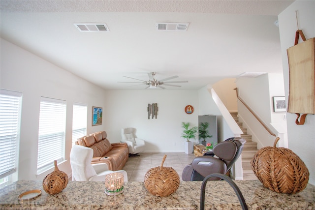 living room featuring ceiling fan and light tile patterned flooring