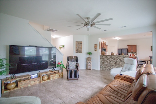 living room with ceiling fan and light tile patterned flooring