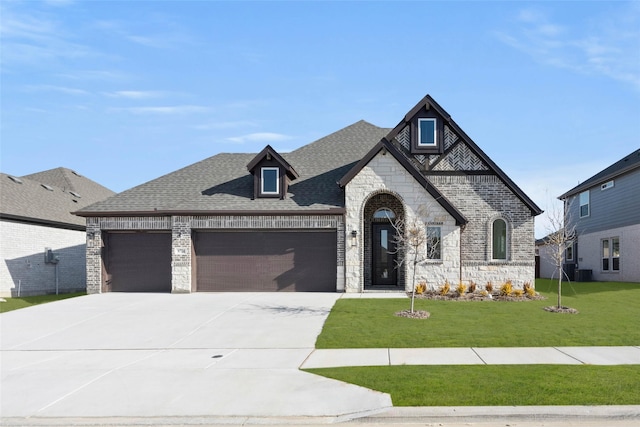 view of front of home featuring a garage, a front yard, and central AC unit