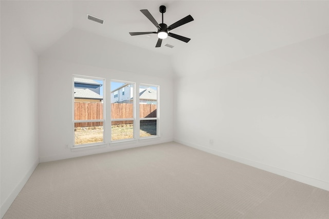 carpeted spare room with lofted ceiling and ceiling fan