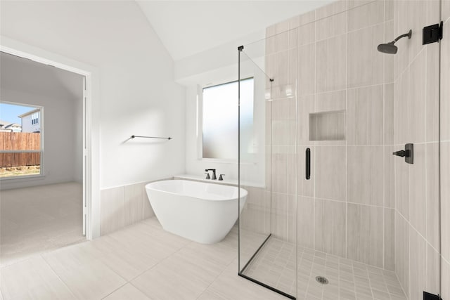 bathroom featuring shower with separate bathtub and lofted ceiling