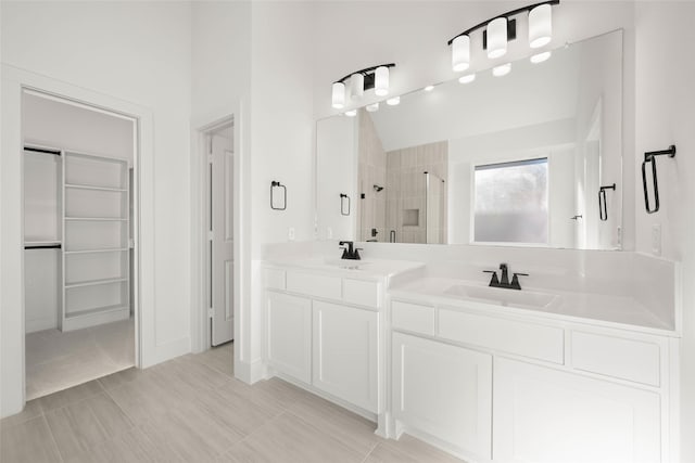 bathroom with vanity, vaulted ceiling, and a shower with door