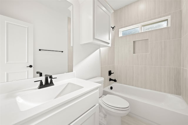 full bathroom featuring vanity, toilet, and tiled shower / bath combo