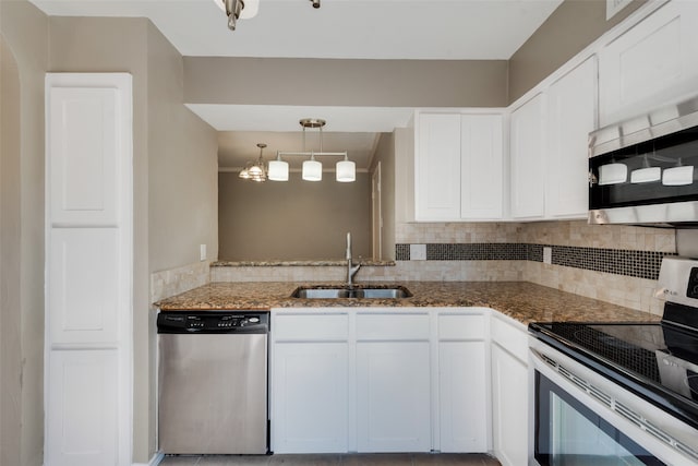 kitchen featuring white cabinetry, appliances with stainless steel finishes, hanging light fixtures, and sink