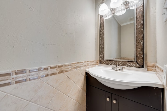 bathroom with vanity, tile walls, and ornamental molding