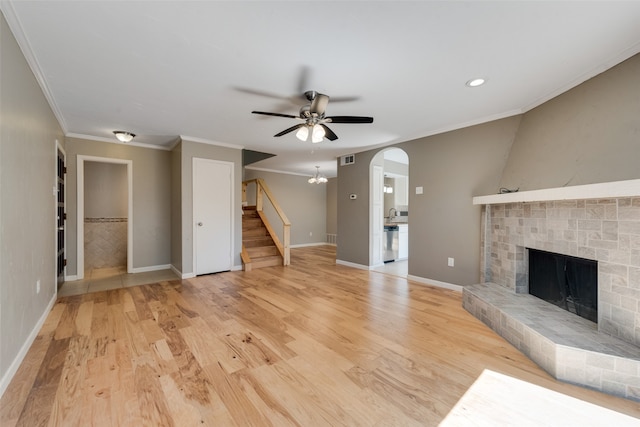 unfurnished living room featuring light hardwood / wood-style floors, ceiling fan, and crown molding