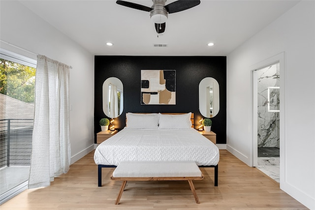 bedroom featuring connected bathroom, access to exterior, ceiling fan, and light hardwood / wood-style flooring