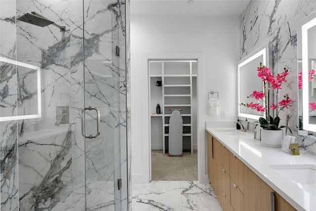 bathroom featuring vanity and a shower with shower door