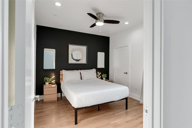 bedroom with light wood-type flooring and ceiling fan