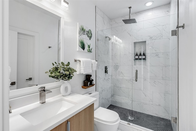 bathroom featuring vanity, toilet, and an enclosed shower