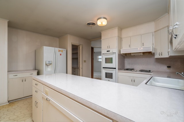 kitchen with white cabinetry, white appliances, sink, and tasteful backsplash