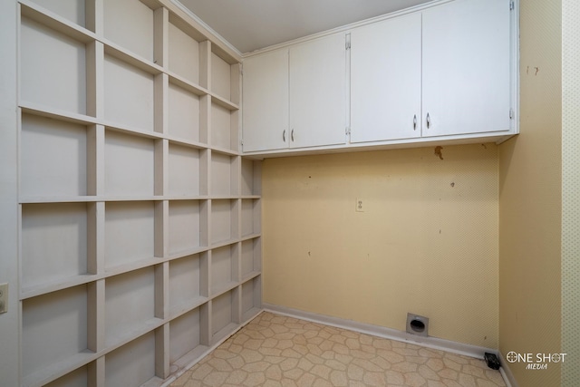 laundry area featuring electric dryer hookup and cabinets