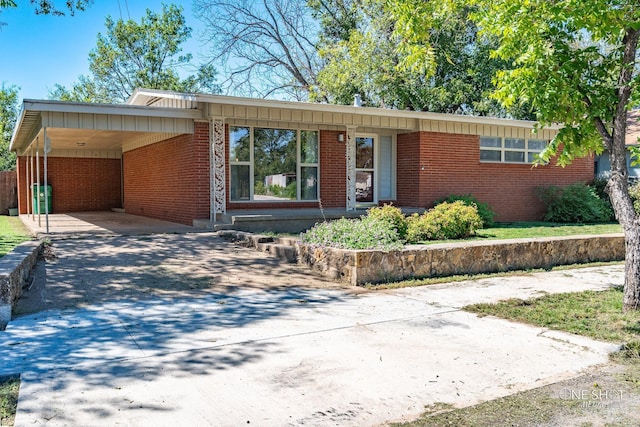 ranch-style house featuring a carport