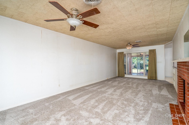 unfurnished living room featuring carpet flooring, ceiling fan, and a fireplace