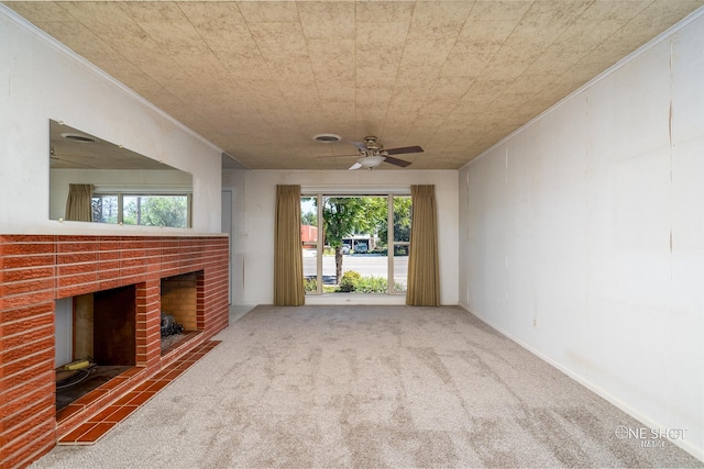 unfurnished living room featuring carpet flooring, ceiling fan, ornamental molding, and a fireplace