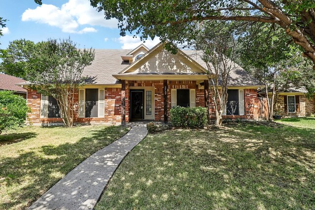 view of front of house with brick siding and a front lawn