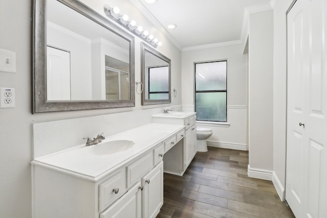 bathroom featuring a shower with shower door, vanity, crown molding, toilet, and hardwood / wood-style floors