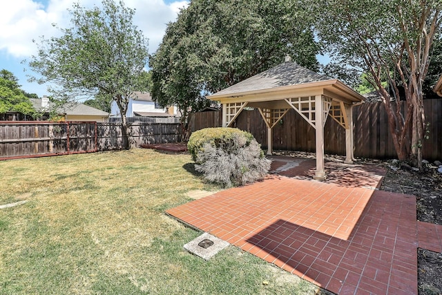 view of yard with a fenced backyard, a gazebo, and a patio area