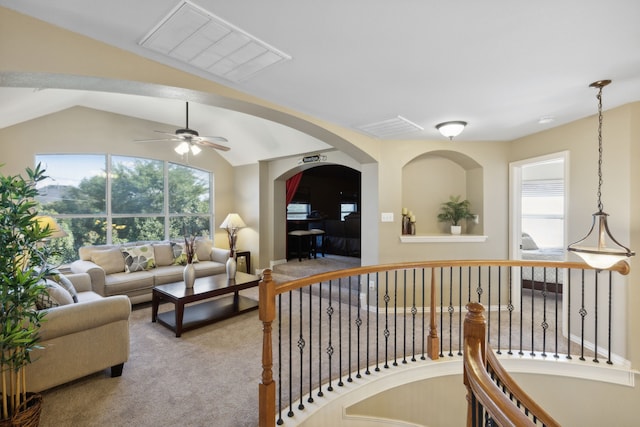 carpeted living room featuring lofted ceiling, ceiling fan, and plenty of natural light