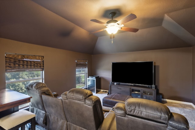 carpeted living room with ceiling fan, lofted ceiling, and a healthy amount of sunlight