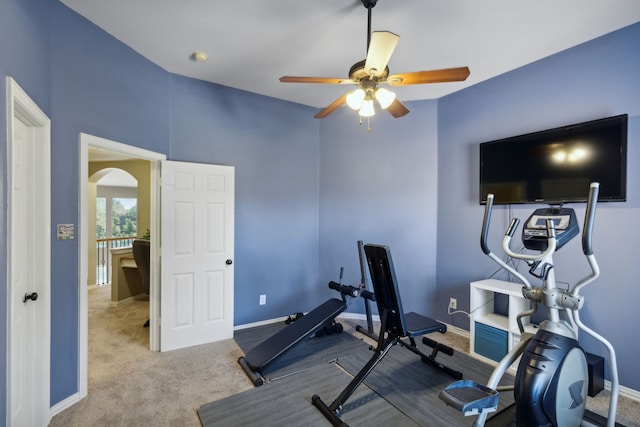 workout area featuring ceiling fan and light colored carpet