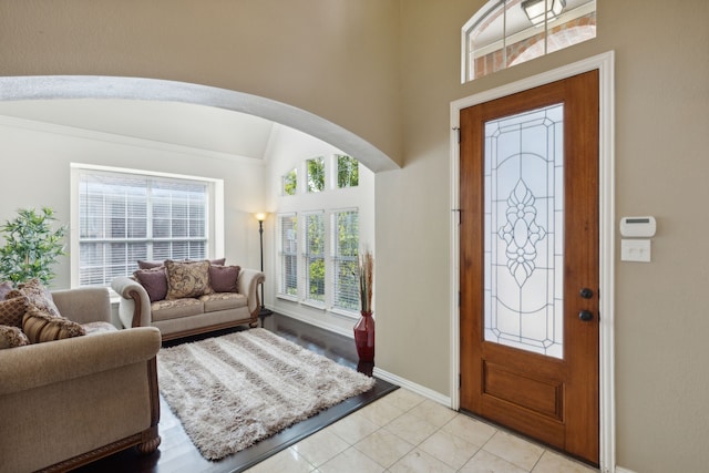 foyer entrance with vaulted ceiling and a wealth of natural light