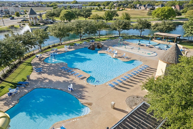 view of pool with a water view and a patio area