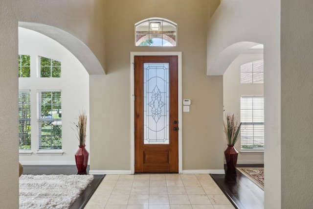 foyer entrance with a towering ceiling and plenty of natural light