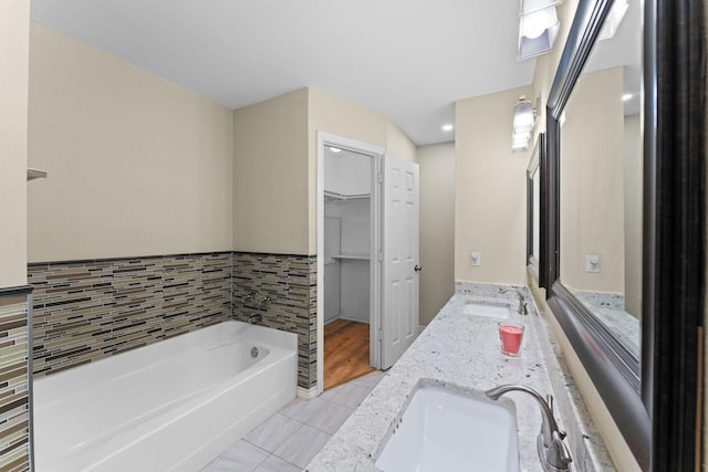 bathroom featuring vanity, a bathtub, and tile patterned flooring