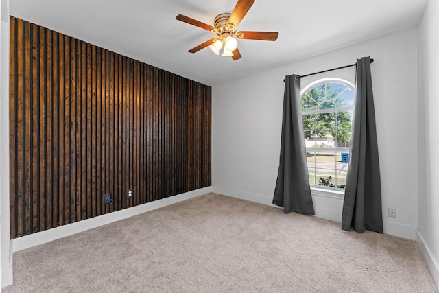 spare room featuring light carpet and ceiling fan