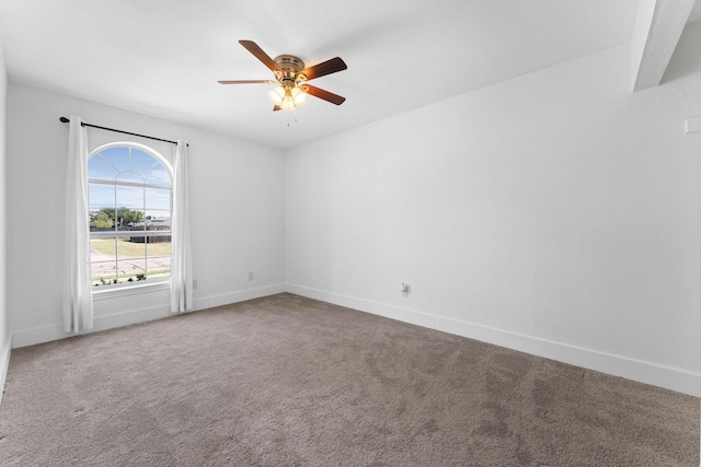 spare room featuring ceiling fan and carpet floors