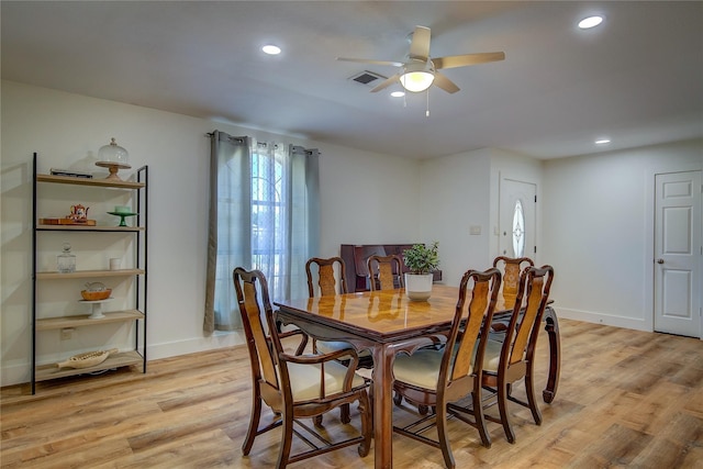 dining space with ceiling fan and light hardwood / wood-style flooring