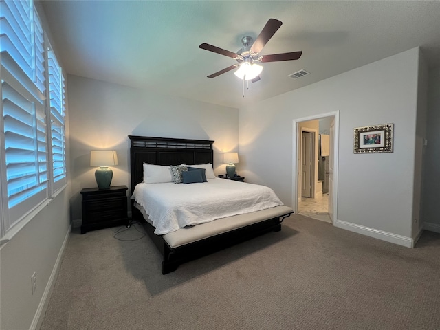 carpeted bedroom with ceiling fan and multiple windows