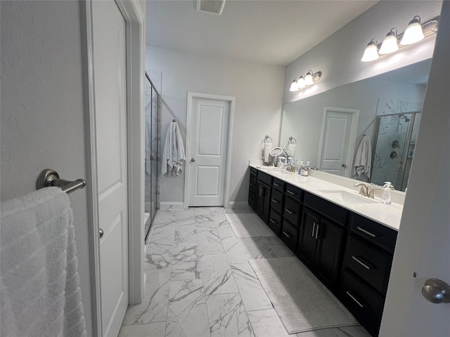 bathroom featuring vanity and a shower with shower door