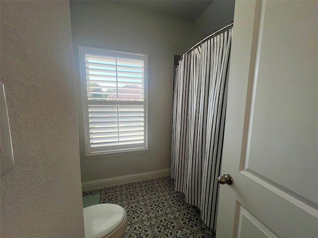 bathroom with toilet and tile patterned floors