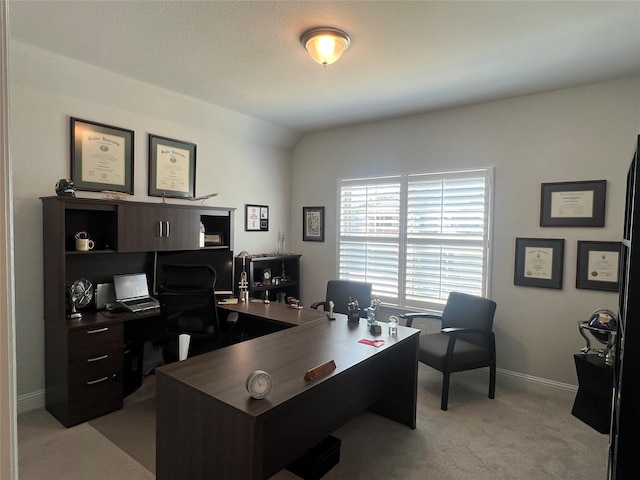 office space with light carpet and lofted ceiling