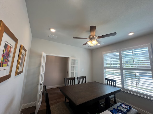 dining room with ceiling fan and dark hardwood / wood-style floors