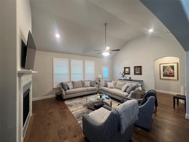 living room featuring lofted ceiling, dark wood-type flooring, and ceiling fan