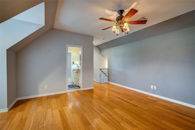 bonus room featuring light wood finished floors, baseboards, visible vents, ceiling fan, and vaulted ceiling