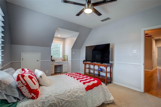 bedroom featuring lofted ceiling, ceiling fan, light carpet, visible vents, and baseboards