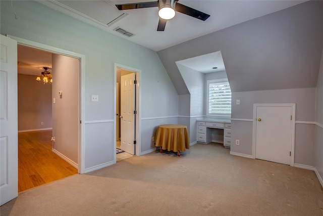 additional living space with vaulted ceiling, light carpet, and ceiling fan