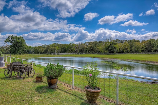 water view with a wooded view and fence